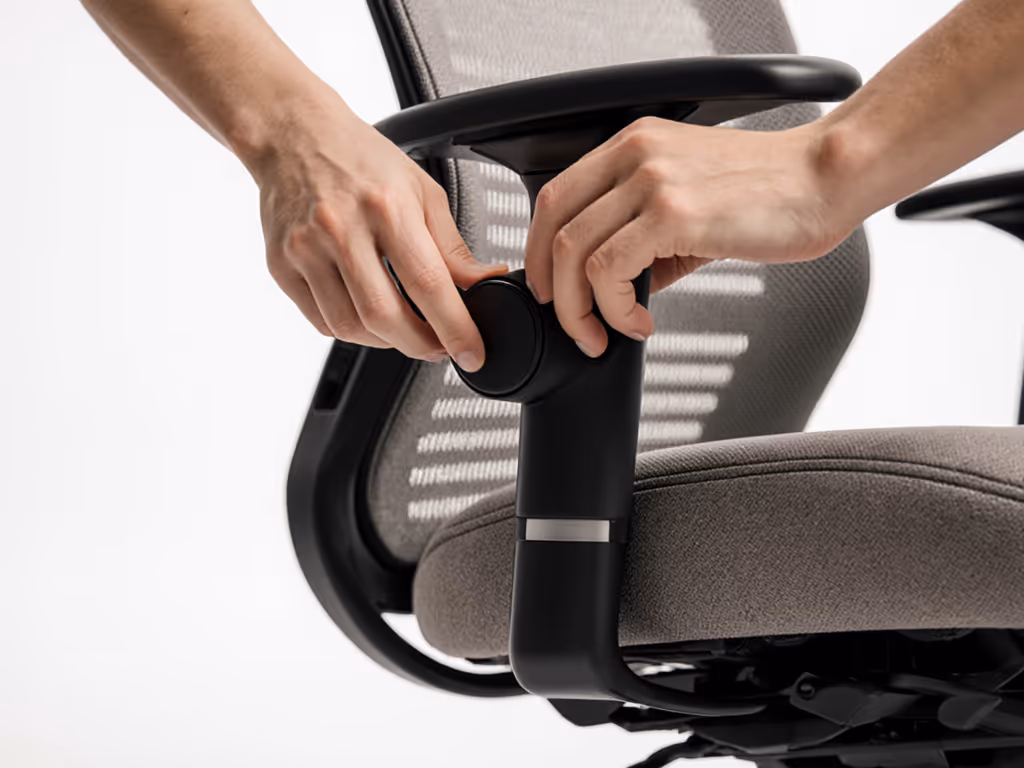 user_adjusting_lumbar_knob_and_footrest_on_branch_chair